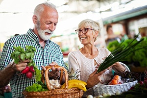 Couple getting vegetables and fruit at the farmer’s market