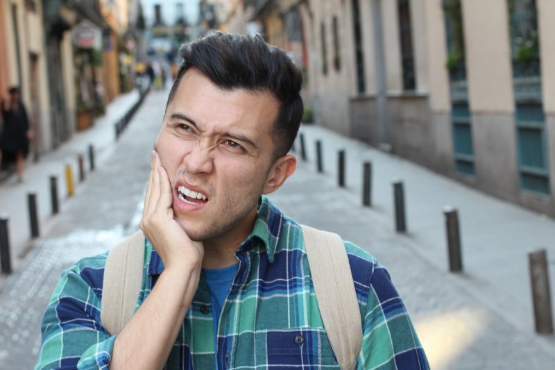 A pained man who grinds his teeth